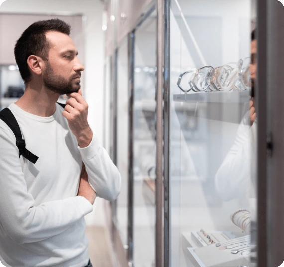 Shopper examining luxury watches in a display
